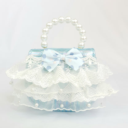 Quilted blue bag with frilly lace