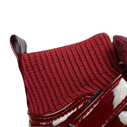 Knitted socks and patent maroon ankle boots